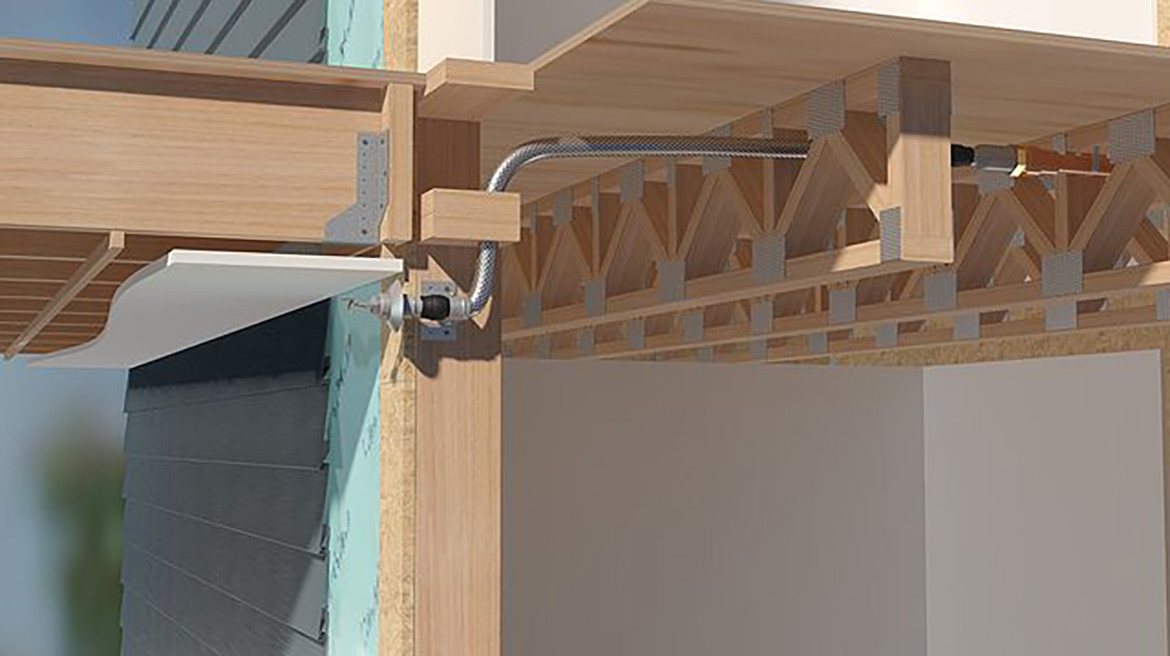 Flexible sprinkler attached to wood construction in a house.