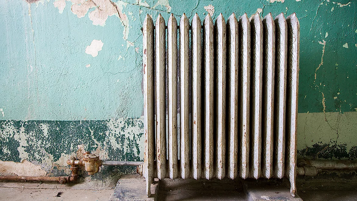 Air Conditioning Condenser Unit Mounted on a Concrete Slab outside of a Suburban Brick Home in Tennessee.