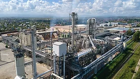 Aerial view of an oil and gas refining petrochemical factory with a high refinery plant manufacturing structure.