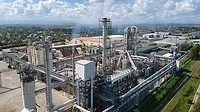 Aerial view of an oil and gas refining petrochemical factory with a high refinery plant manufacturing structure.