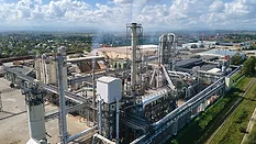 Aerial view of an oil and gas refining petrochemical factory with a high refinery plant manufacturing structure.
