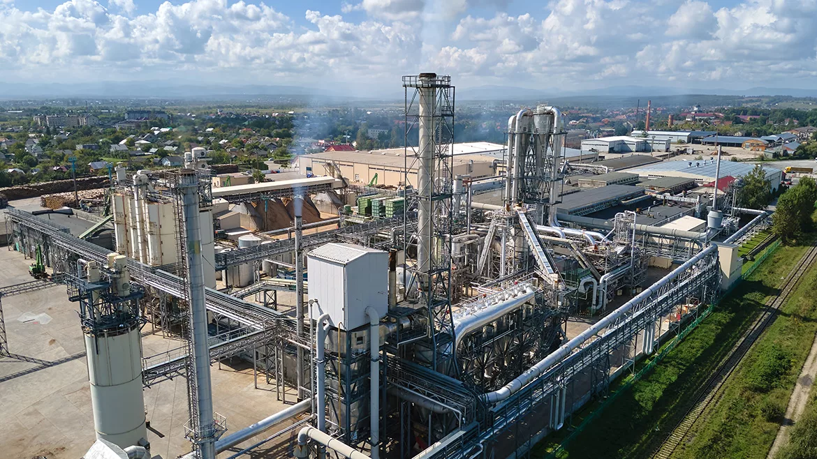 Aerial view of an oil and gas refining petrochemical factory with a high refinery plant manufacturing structure.