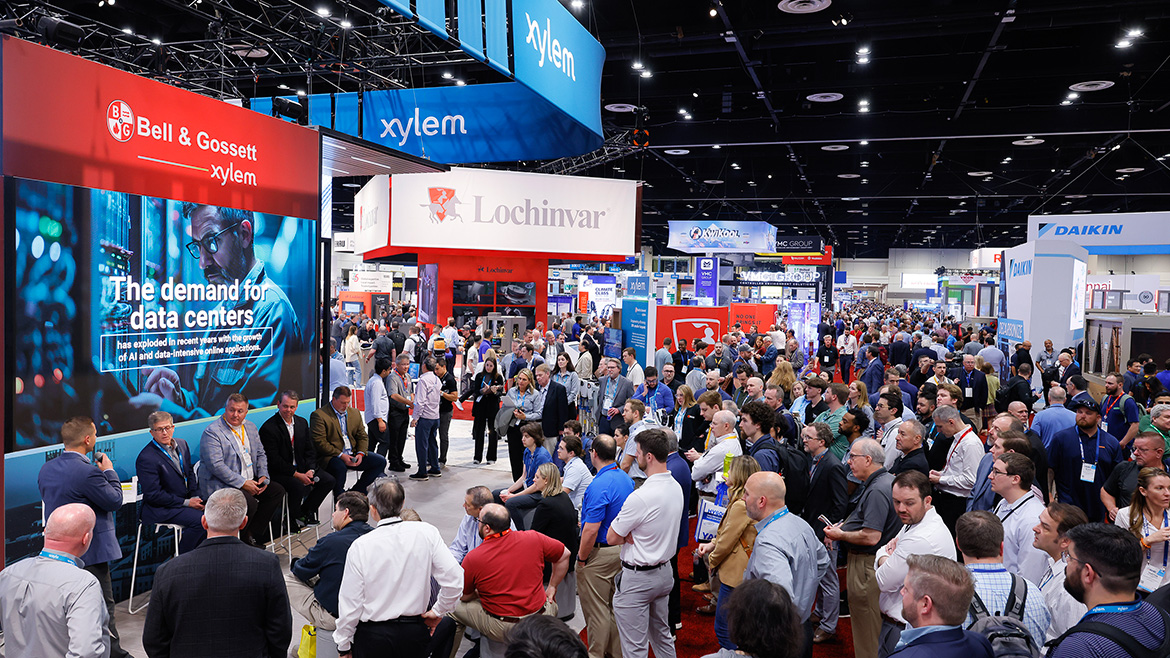 Crowd of attendees listening to a group on stage at the AHR Expo.