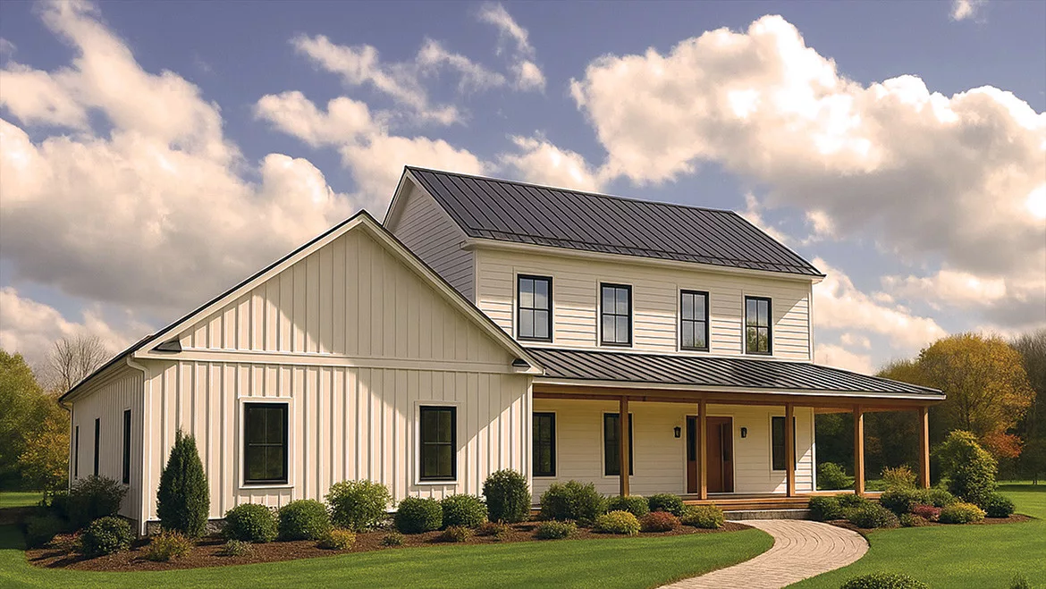 An exterior shot of a Connecticut home designed by architect Leigh Overland. Partial view of front landscape, cloudy blue sky in the background.