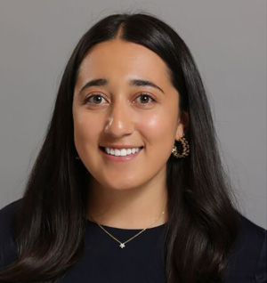 Tara Denning headshot with a gray background.