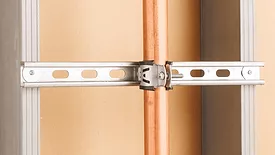 Commercial pipe support system installed on a wall.