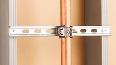 Commercial pipe support system installed on a wall.