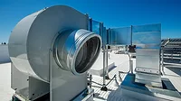 Fans and ducting for ventilation in a rooftop HVAC system.