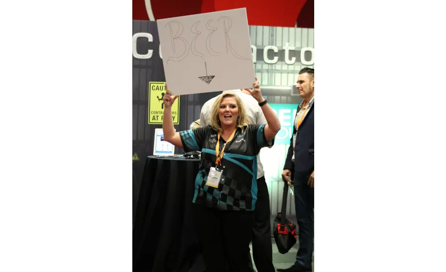 Amanda McCarty, marketing and accounting professional for Service Roundtable, advertises free beer to draw attendees of the inaugural Service World Expo to the organization’s booth.