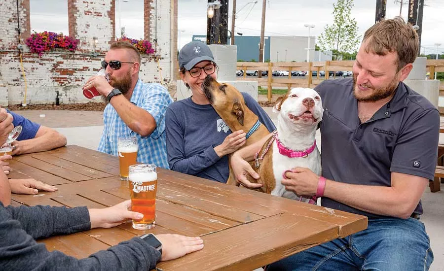 A gathering of mployees and patrons enjoy the beer garden