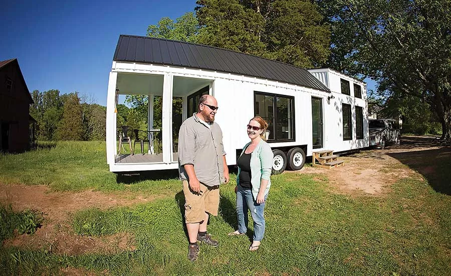 Tiny-home builders Johanna and Tom Elsner stand in front of one of their homes