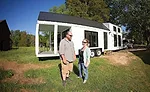 Tiny-home builders Johanna and Tom Elsner stand in front of one of their homes