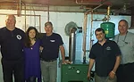 Pictured alongside the new boiler are George Perelli, William Casey, and his sister, Beth Casey