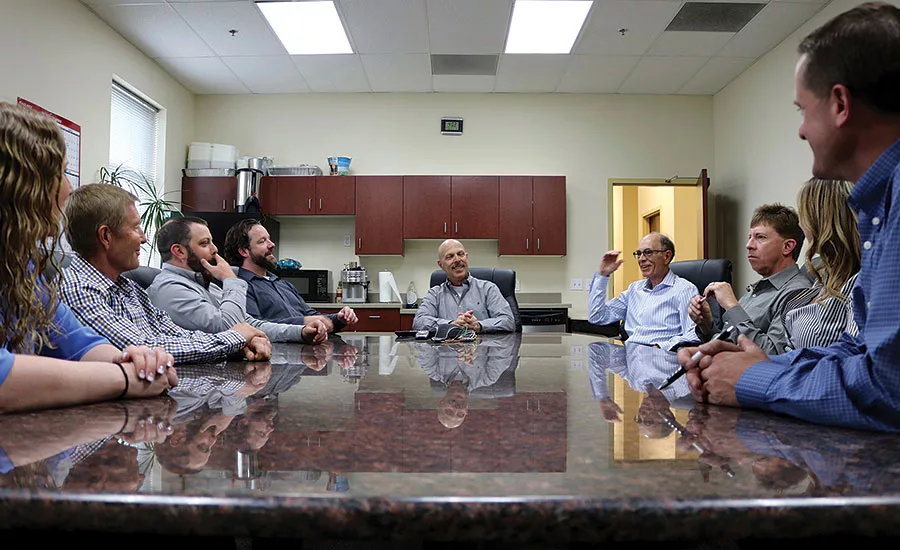 TM Sales founder Tom Meek (center) holds a meeting with his outside sales reps at the company’s Arvada, Colorado
