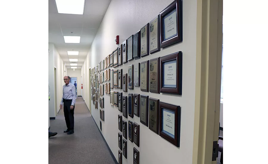 One wall of a hallway at TM Sales’ headquarters in Arvada, Colorado