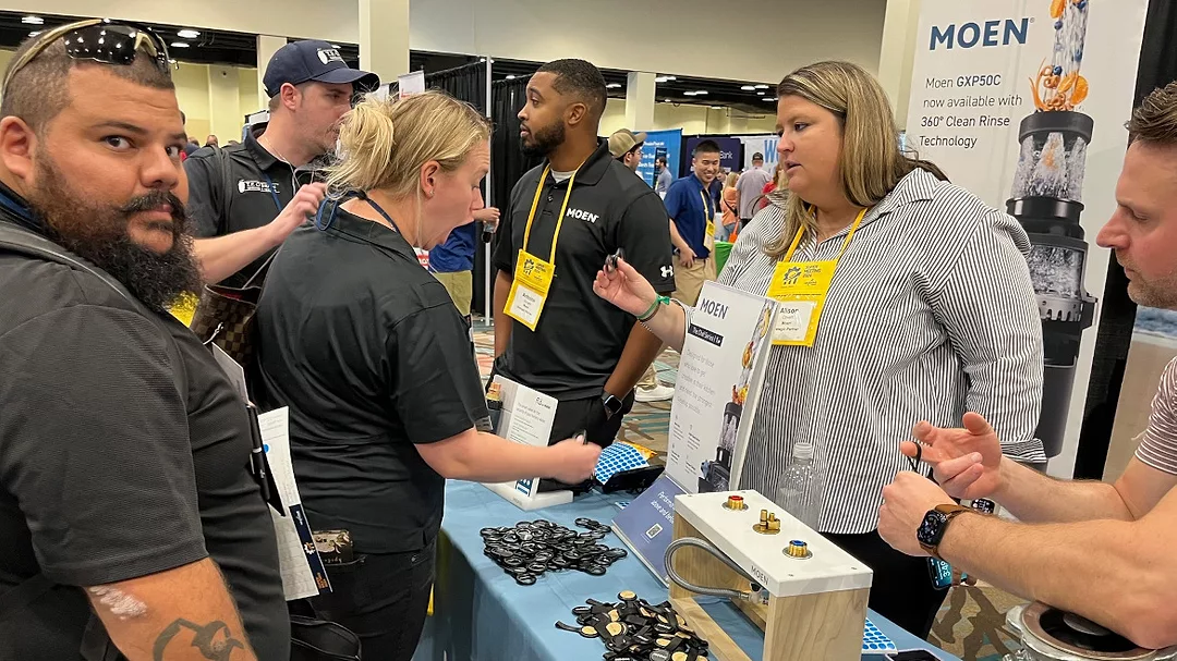 Nexstar Network members stop at the Moen booth.