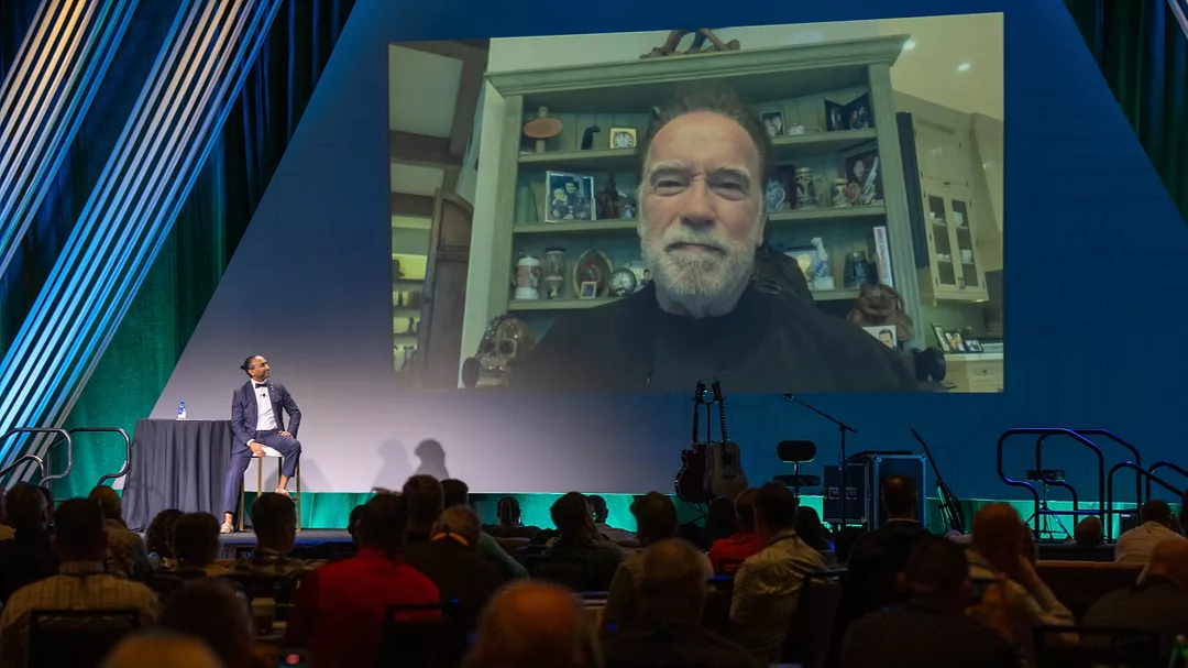 Nexstar Network Julian Scadden Hosts Arnold Schwarzenegger virtually at Super Meeting 2024.